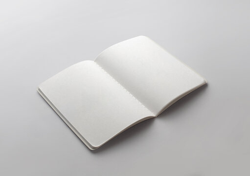 Perspective view of blank open notebook mockup with stitched binding on white background