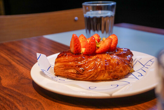 Strawberry Danish Pastry on a White Plate in a Cafe
