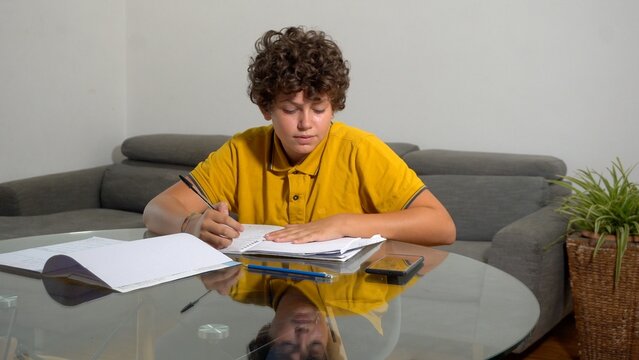 12 year old boy child suffering from a migraine headache &ndash; student experiencing head pain and fatigue stress from homework and studying -  Fever, illness, and medical care in childhood