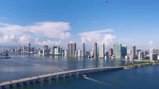 Aerial view of the Julia Tuttle Causeway crossing Biscayne Bay with the Miami skyline in the background under a clear blue sky in Miami, Florida, United States.