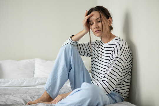 Sad woman sitting alone at home in a depressive mood, representing loneliness, emotional distress and mental health struggles