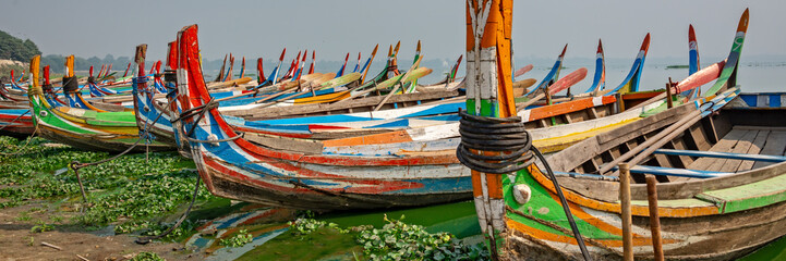 Colorful traditional wooden row boats in Amapura, near U Bein bridge, Mandalay, Burma Myanmar © Delphotostock
