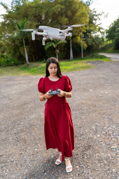 A young woman piloting a professional drone for audiovisual purposes