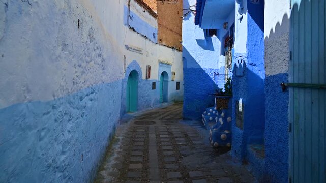 Walking through a narrow blue street in Chefchaouen, Morocco