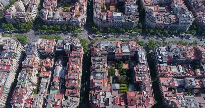 Aerial view of the Eixample district in Barcelona, featuring its iconic grid layout, octagonal city blocks with inner courtyards, and red rooftops in Barcelona, Catalonia, Spain.