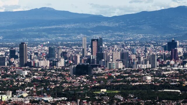 Aerial view of the Mexico City skyline with modern skyscrapers and urban sprawl under a clear sky in Mexico City, Mexico City, Mexico.
