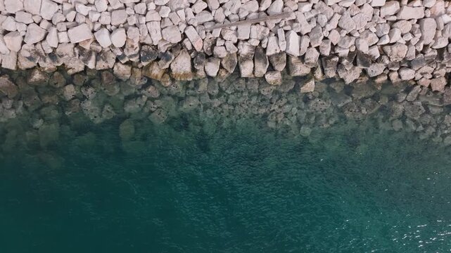 Aerial view of the rocky coastline at Marina Polesana Pula with clear turquoise sea water in Pula, Istarska zupanija, Croatia.