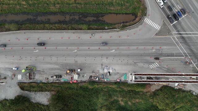 Overhead View Of Cars Driving On Fraser Highway Along The Construction Site Of Surrey Langley Skytrain Line In Surrey, BC, Canada. - aerial shot