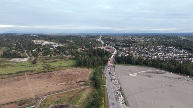 Aerial View Of Rural Fields, Highway, Ongoing Construction And Residential Houses In Surrey, BC, Canada.