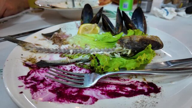 Leftover Fish and Mussels on Plate After Seafood Dinner