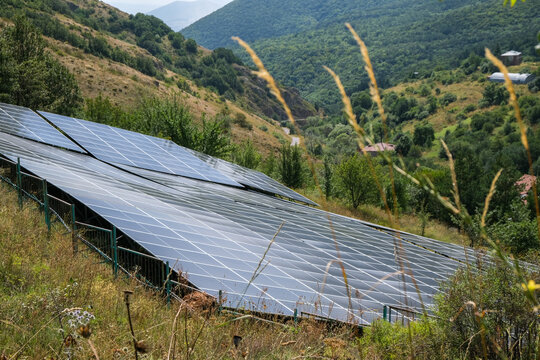 Large solar panel complex covering several hundred square meters in the mountains, generating the required power for renewable energy infrastructure and sustainable electricity production.
