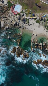 Top down aerial view of Maiden's Cove Tidal Pool in Clifton, Cape Town, South Africa, 4K vertical video.	