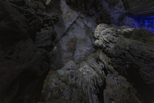 Dramatic Karst Cave Interior With Stalactites and Blue Light
