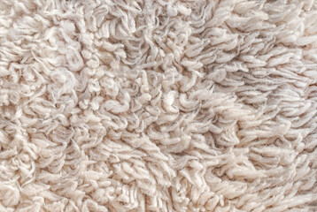 Natural beige sheepskin wool fleece texture background © Alexa Joy