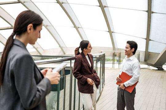 Business Colleagues Discussing Work on Modern Office Terrace
