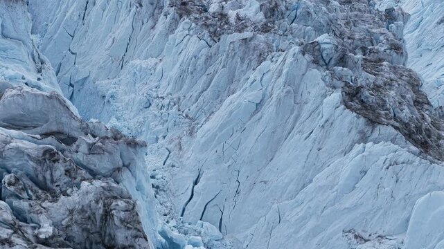 Aerial view of the massive blue ice formations and deep crevasses of the Ilulissat Glacier in Ilulissat, Avannaata Municipalit, Greenland.
