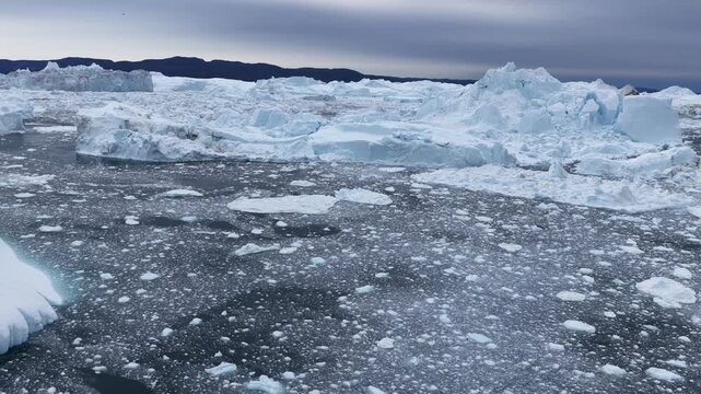 Aerial view of massive icebergs and floating sea ice in the Ilulissat Icefjord, Ilulissat, Avannaata Municipalit, Greenland.