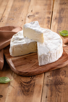 Fresh Brie cheese with herbs. Camembert cheese.