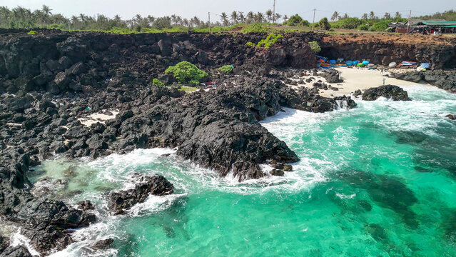 Aerial drone view of volcanic rocks and turquoise sea at Cong To Vo Mini