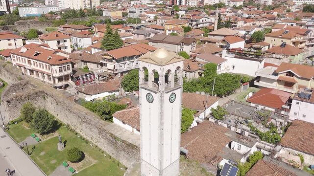 An captivating aerial orbit reveals the historic Elbasan Clock Tower, standing tall amidst Albania's charming urban landscape.