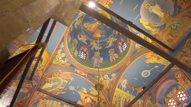 Colorful Orthodox frescoes cover the domed ceiling of the Church of Saints Clement of Ohrid and Panteleimon.