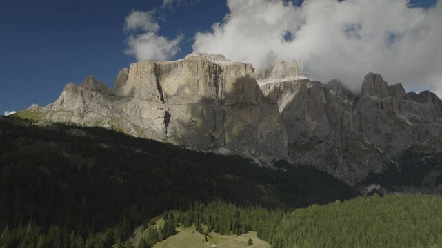 An aerial view of the Sella towers near the Sella pass with clouds after a storm, Canazei, Italy