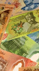 Brunei Darussalam dollar money bills in pile on table. Brunei BND currency cash close up © Viktor