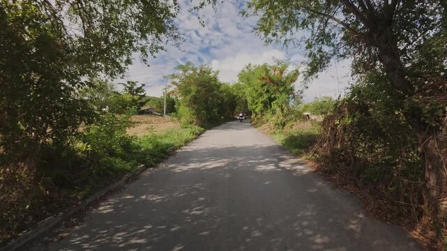 A tracking shot of motorcyclists riding on a gravel road near Ancona, Italy