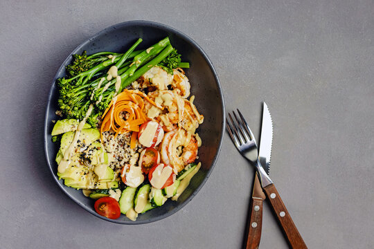 Shrimp quinoa bowl with avocado, broccolini and tahini dressing