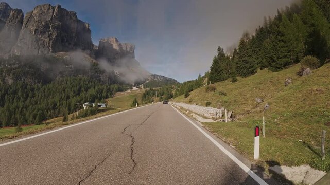 A tracking shot moving down a winding road near the Gardena Pass, Italy