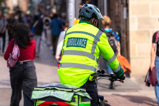 Ambulance paramedic bicycle quick response on a city road in the UK responding to emergency