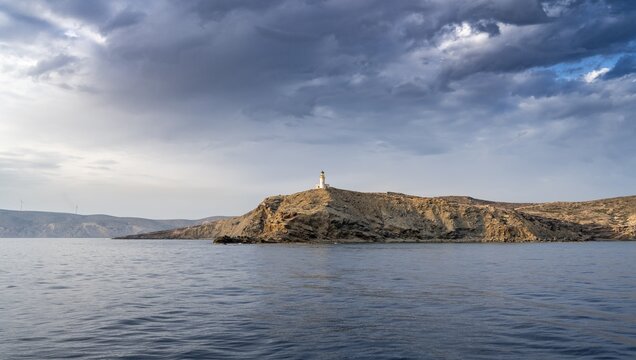 Prasonisi lighthouse in evening light, dramatic cloudy sky, Rhodes, Dodecanese, Greece