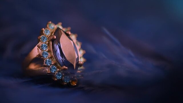 Closeup of luxury gemstone ring in blue feather. Precious jewellery macro still life. Elegant fashion accessories sapphire jewels diamond gem. Classy wedding, bridal, engagement topaz ring.