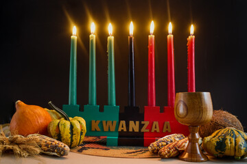 Fototapeta premium Kwanzaa kinara with mishumaa saba and harvest symbols