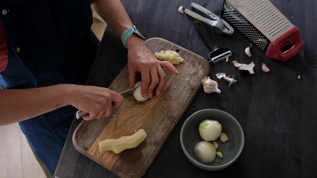 Close-Up Top View Of A Woman Cutting Onion