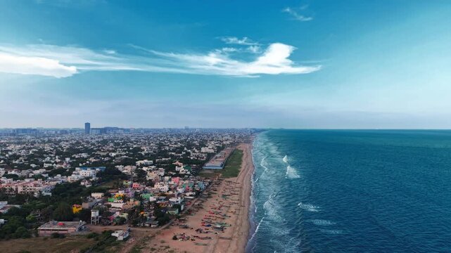 Blue Sea Surf Along a Sandy Beach and Coastal Neighborhood