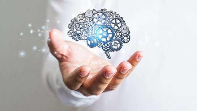 Human hands holding floating brain made of metal gears isolated on light background