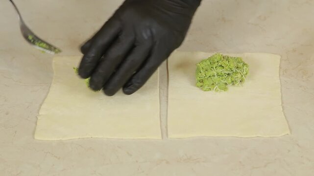 Green pea and almond filling placed on squares of puff pastry
