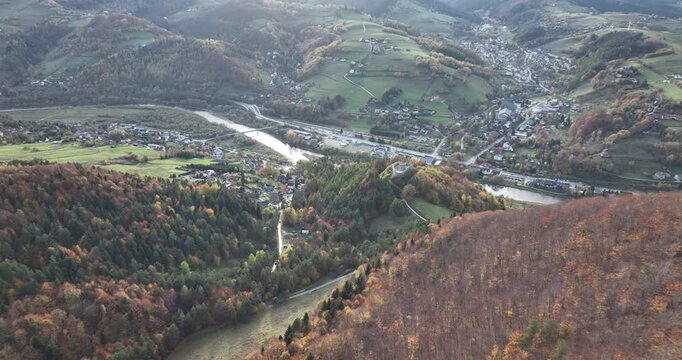 Aerial flyover of Rytro village and castle ruins in autumn