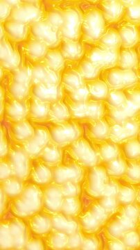 Shimmering bright golden organic cells and bubbling glossy fluid matter in a vertical microscopic abstract 3D animation