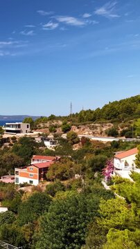 Croatia, sunny day, coastal landscape, pine trees, houses, hills