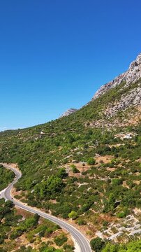 Croatia, aerial view of a winding road through a mountainous landscape