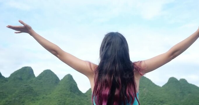 Unrecognizable Woman Enjoying a Scenic Karst Mountain Landscape in China