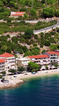 Croatia, aerial footage of coastal town with hotels, beach and Adriatic sea