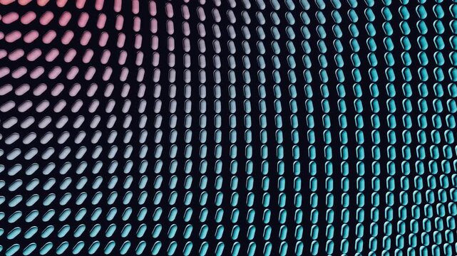 Multicolor capsule shapes swirl in a vortex array from warm orange to pastel pink and blue against a dark background