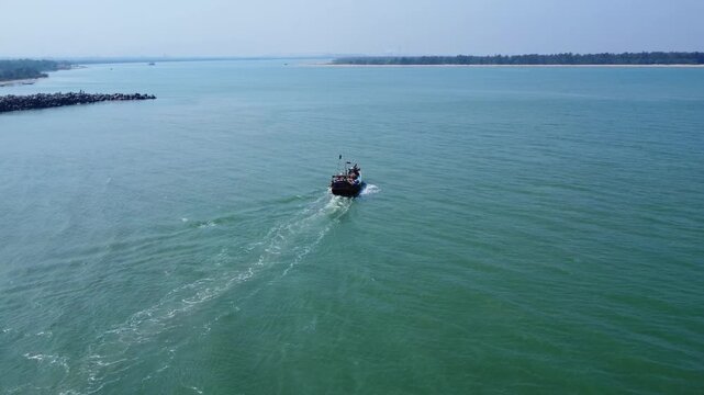 Aerial View of Fishing Boat Navigating Near River Mouth and Sea Horizon