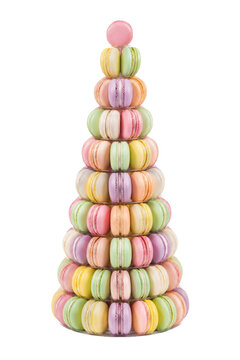 Beautiful colorful pyramid of delicious French macarons arranged on a clear stand, isolated on a clean white background