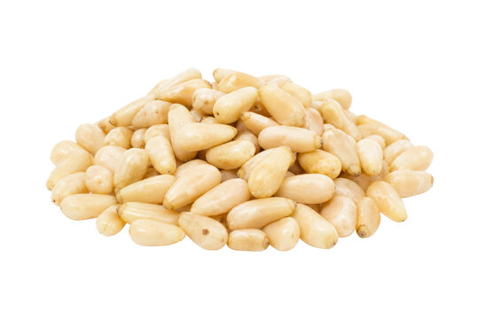 Large pile of raw, shelled, light yellow pine nuts is neatly arranged on a clean white background