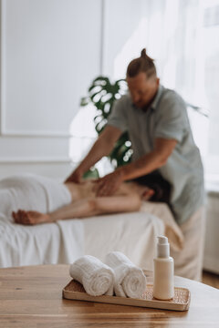 Man performing back massage on client in tranquil clinic setting