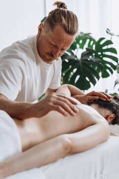 Man giving woman back massage for relaxation and muscle relief